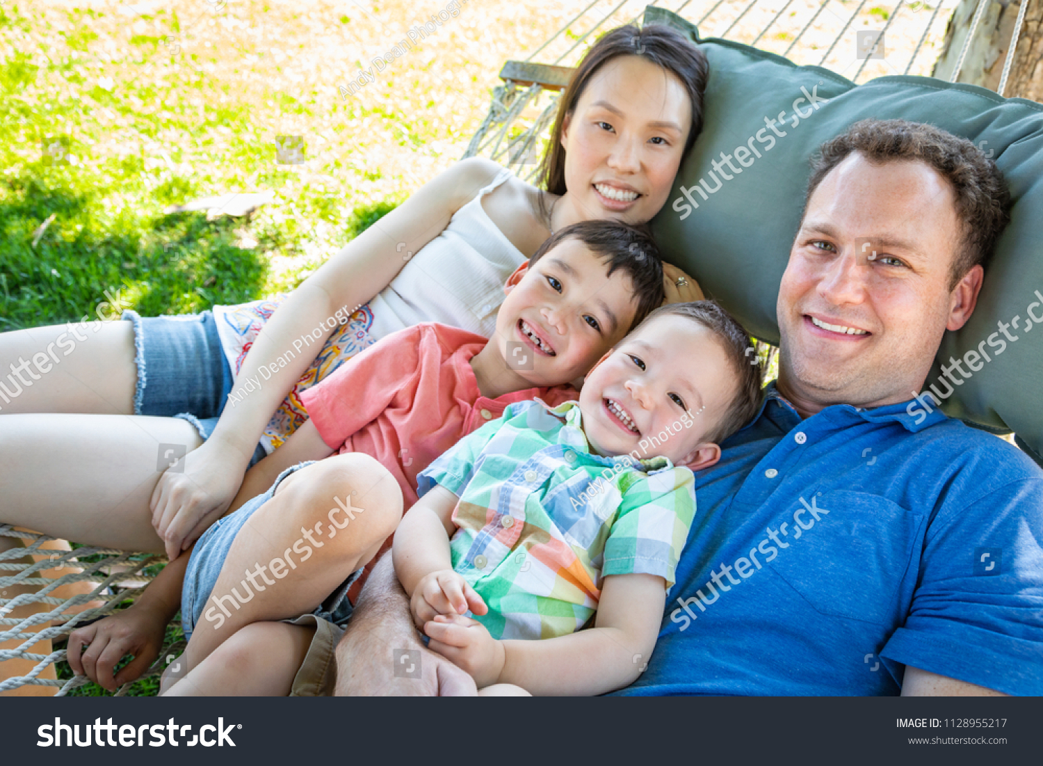 stock-photo-caucasian-father-and-chinese-mother-relaxing-in-hammock-with-mixed-race-sons-11289...jpg